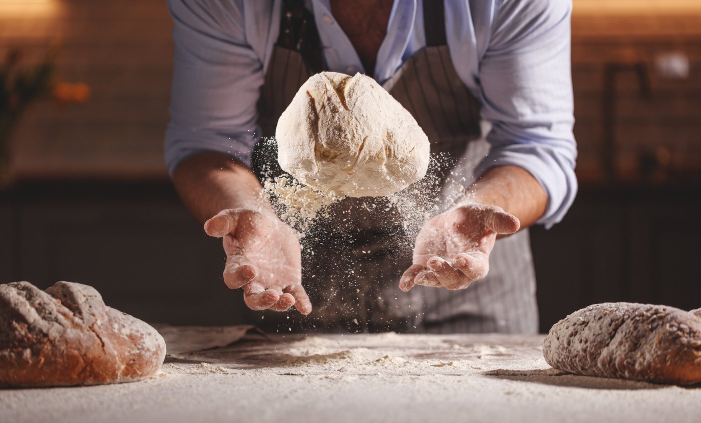 hands of baker's male knead dough